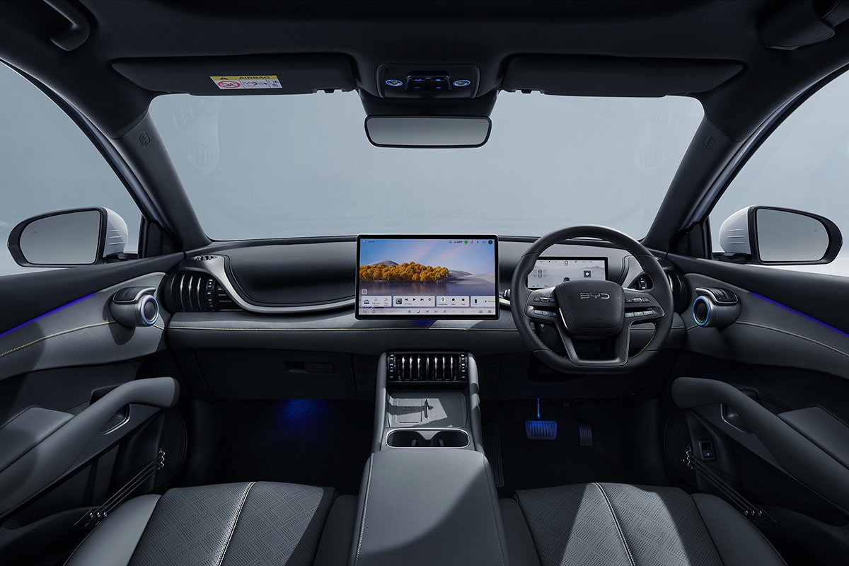 Interior cabin view of the BYD ATTO 3 EVO featuring ambient lighting and floating center console