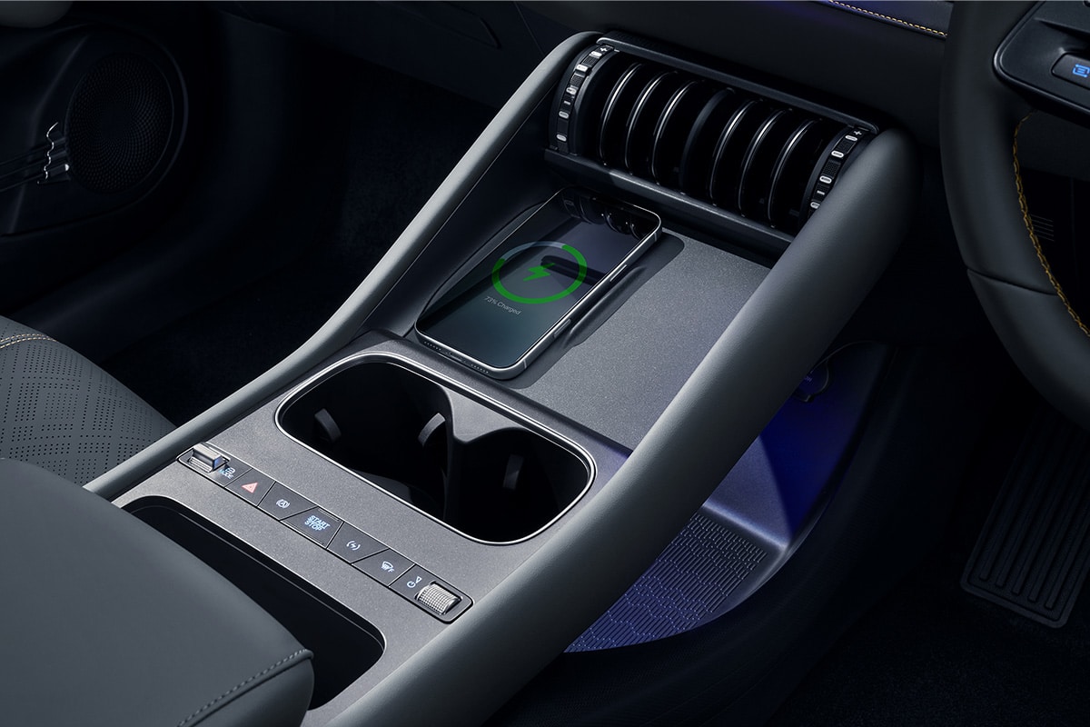 BYD ATTO 3 EVO center console with toggle switches, cupholders, and wireless charging pad
